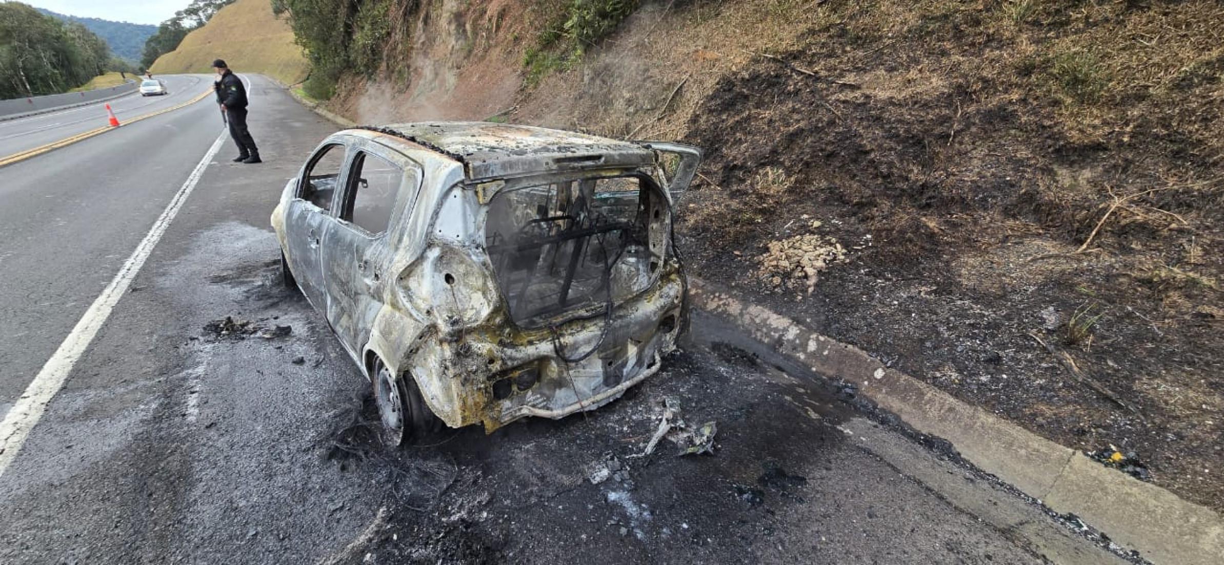 Veículo foi completamente destruído pelas chamas após falha nos freios; condutor e passageiro conseguiram escapar sem ferimentos