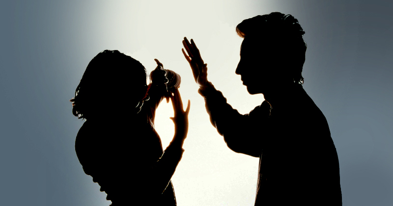  MODEL  RELEASED.    Domestic violence.  Silhouette of a woman protecting herself from a blow from her partner by holding her arms in front of her face.