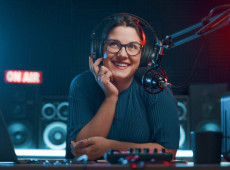  Cheerful female radio DJ hosting a radio show, entertainment and communication concept