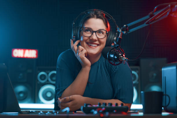 Cheerful female radio DJ hosting a radio show, entertainment and communication concept