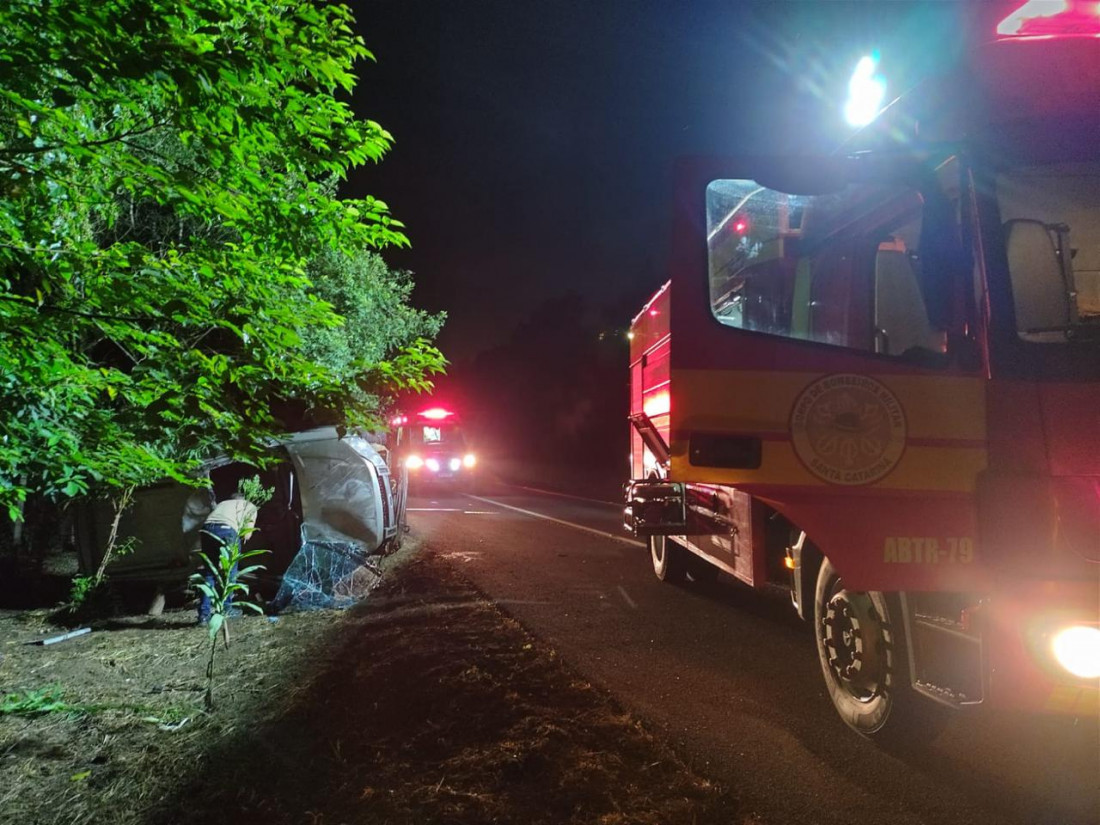 Mulher de 25 anos ficou presa no carro tombado e foi resgatada pelos bombeiros com suspeita de fratura.